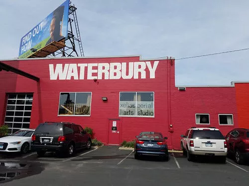 Red building with Waterbury painted on the site