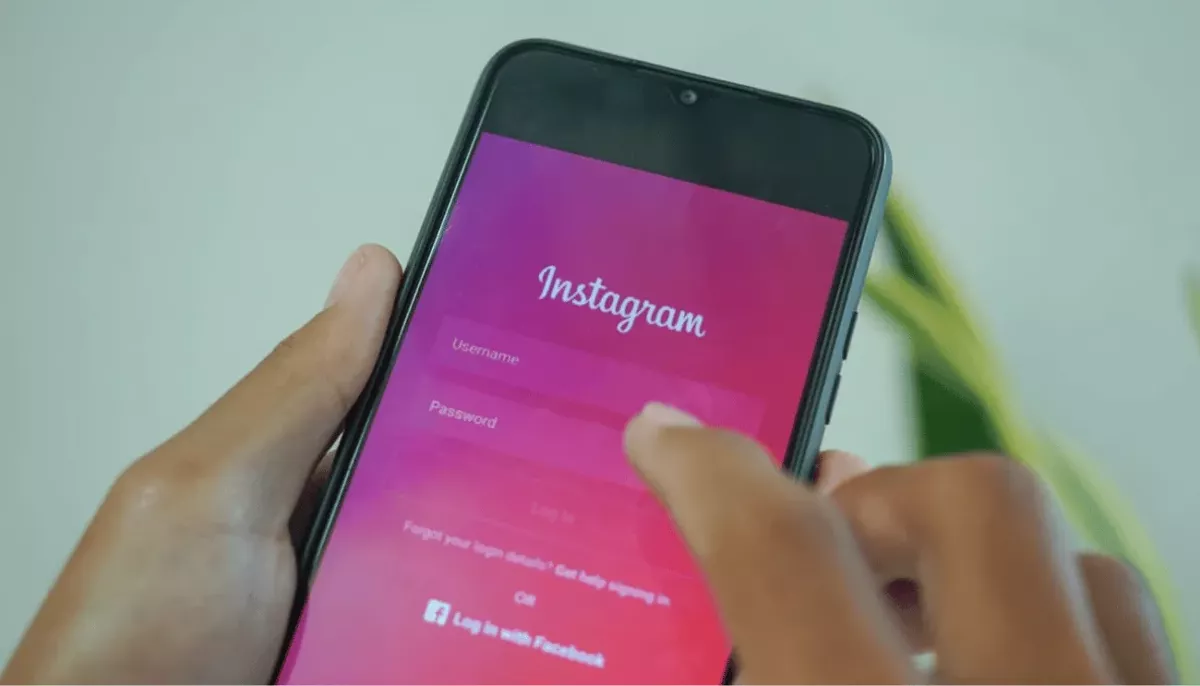 A person logging into Instagram on their phone