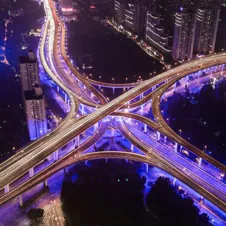 A network of illuminated highways at night, representing smooth and efficient system integration.