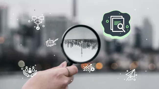 A magnifying glass held up to a cityscape. High Monkey’s service icons are overlaying the image, the search icon is highlighted.