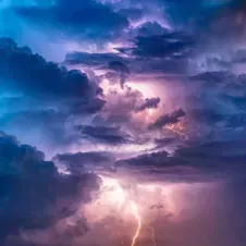 A dramatic stormy sky with lightning, symbolizing boldness, honesty, and direct communication.
