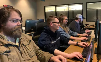 Four students in a computer lab.