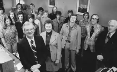 A historical black-and-white photo of the original Royal Credit Union team, showing early leadership and staff.