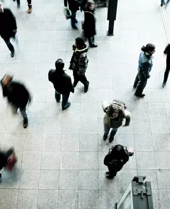 A busy public space with blurred motion, symbolizing fast-paced corporate environments and large-scale commerce.